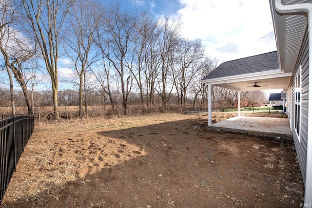 view of yard featuring ceiling fan and a patio area