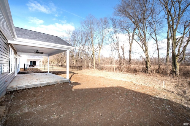 view of yard with ceiling fan and a patio