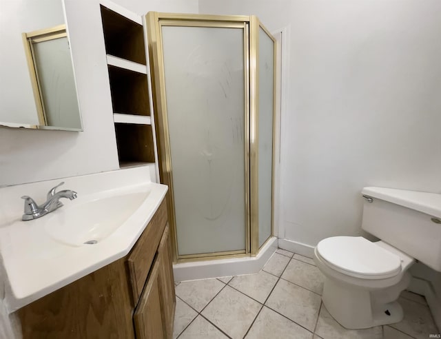 bathroom featuring a shower with door, vanity, tile patterned flooring, and toilet