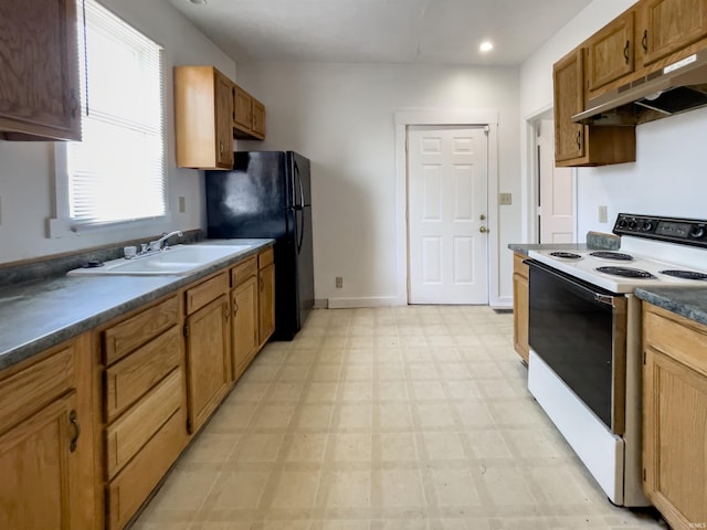 kitchen with electric stove, black refrigerator, and sink