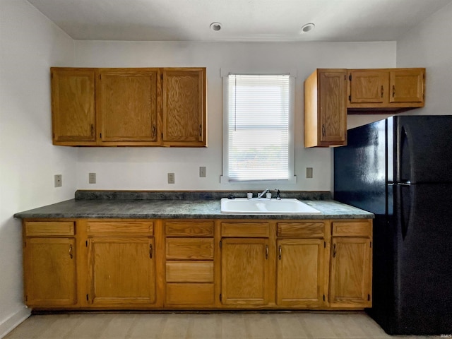 kitchen with black fridge and sink