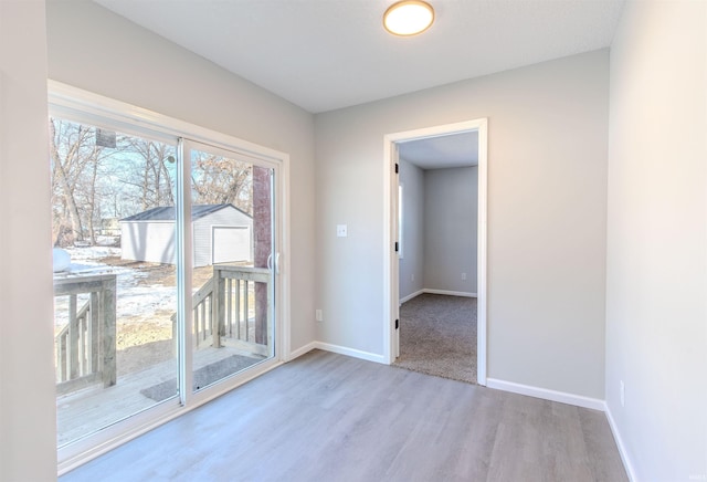 empty room with light hardwood / wood-style floors