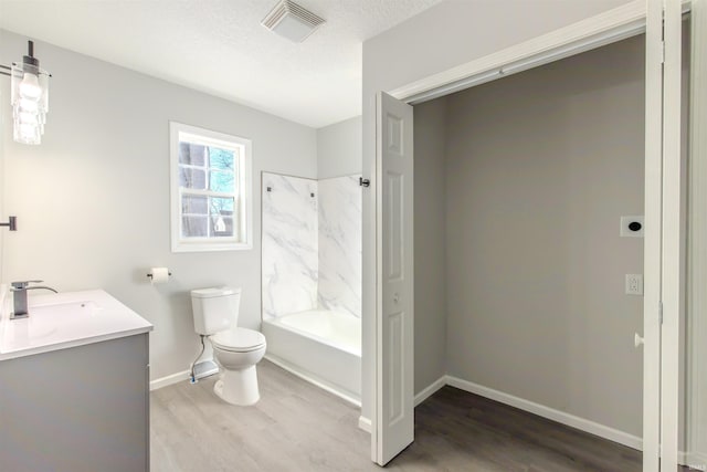 full bathroom featuring vanity, hardwood / wood-style flooring, shower / bathtub combination, and toilet