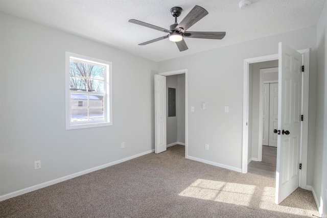 unfurnished bedroom with light colored carpet, a textured ceiling, and ceiling fan