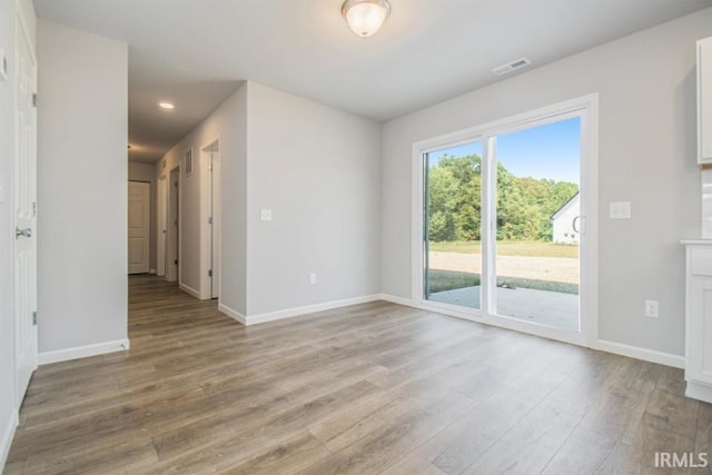 spare room featuring light wood-type flooring