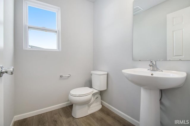 bathroom with sink, wood-type flooring, and toilet