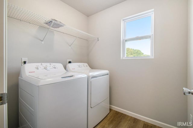 laundry area with washer and clothes dryer and hardwood / wood-style floors