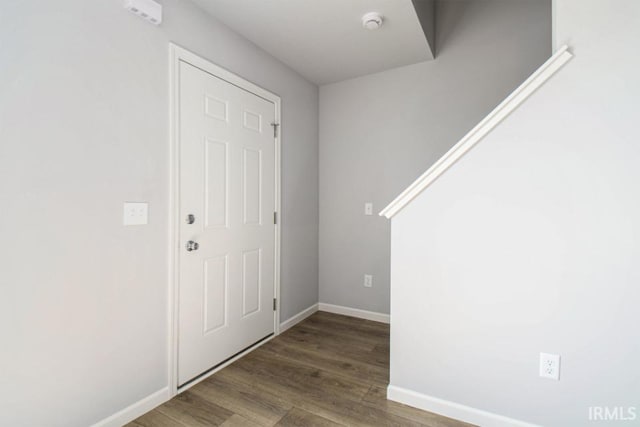 entryway with dark hardwood / wood-style flooring