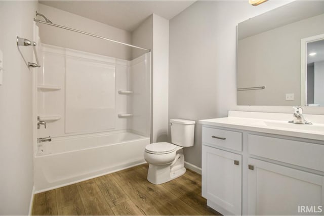 full bathroom with shower / bathing tub combination, vanity, wood-type flooring, and toilet