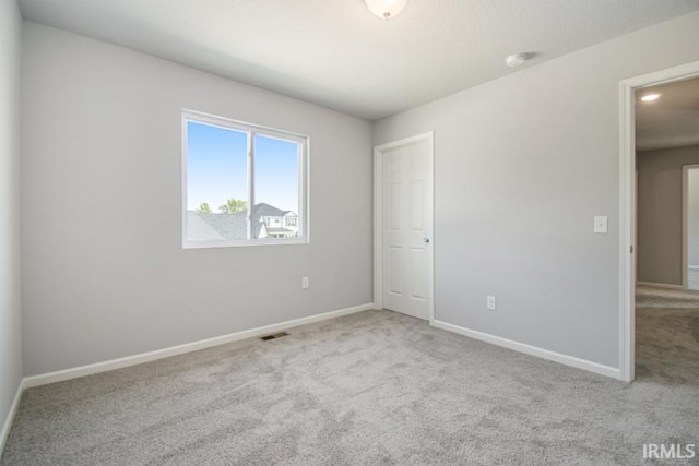 spare room with light carpet