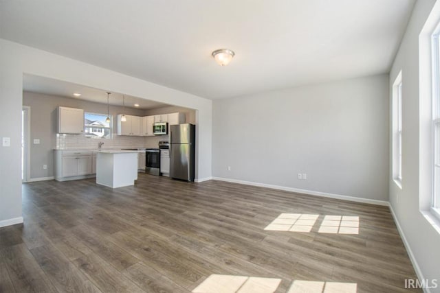 unfurnished living room featuring dark wood-type flooring