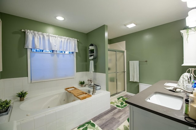 bathroom featuring vanity, hardwood / wood-style floors, and shower with separate bathtub