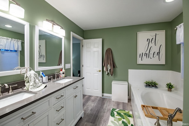 bathroom featuring vanity, wood-type flooring, and a washtub