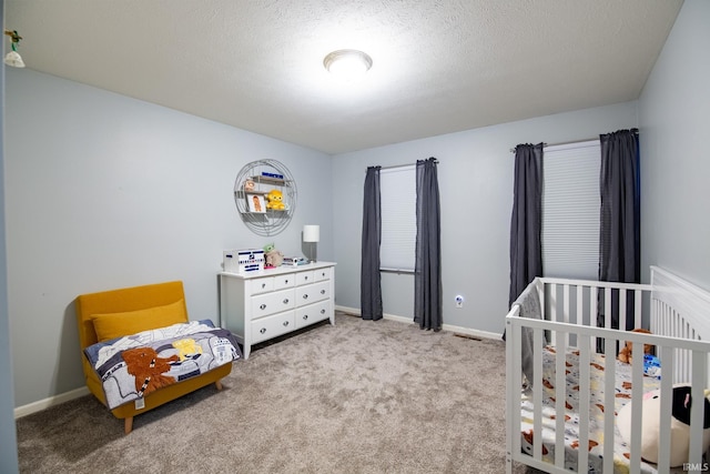 bedroom featuring light colored carpet and a textured ceiling