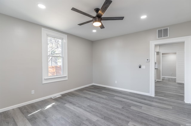 spare room featuring hardwood / wood-style flooring and ceiling fan