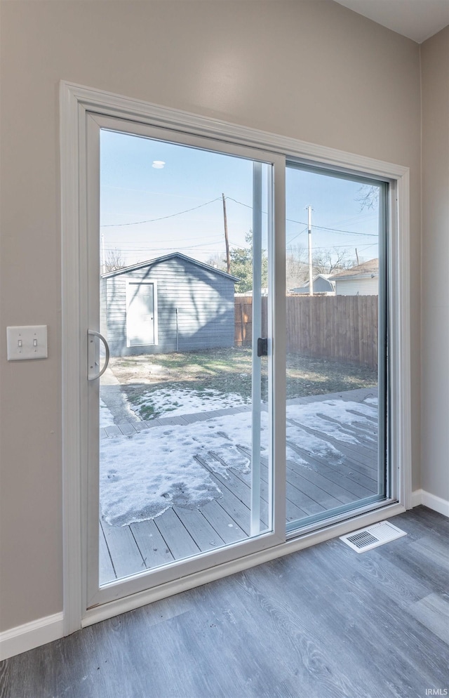 doorway to outside with dark wood-type flooring