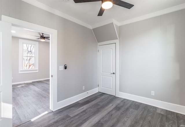 spare room with dark wood-type flooring, ceiling fan, and ornamental molding