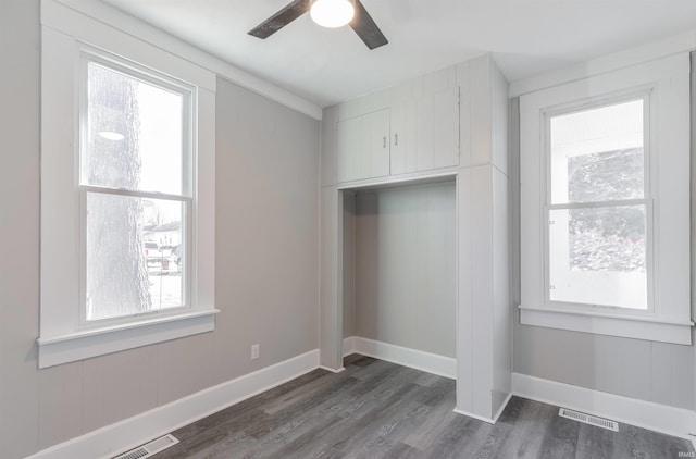 unfurnished bedroom with dark hardwood / wood-style flooring and ceiling fan