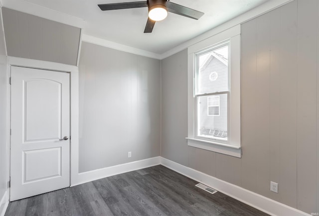 spare room with ornamental molding, dark hardwood / wood-style floors, and ceiling fan