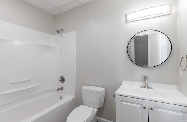 full bathroom with vanity, a paneled ceiling, shower / bathtub combination, and toilet