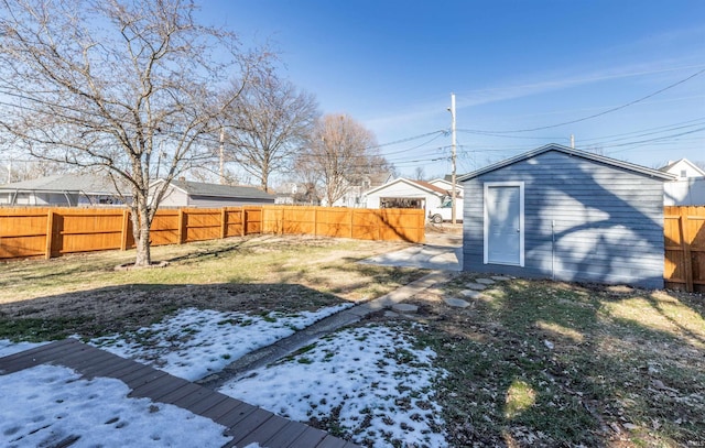 snowy yard with an outbuilding