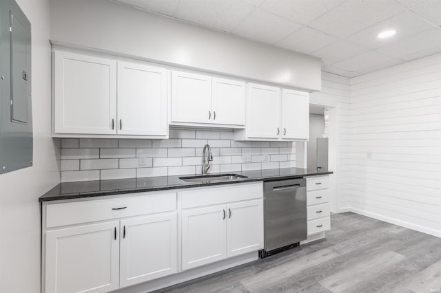 kitchen with dishwasher, sink, white cabinets, electric panel, and light hardwood / wood-style flooring