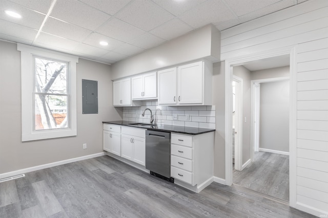 kitchen featuring light wood-type flooring, dishwasher, sink, and white cabinets