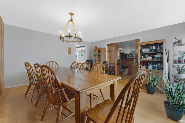 dining room featuring light hardwood / wood-style floors and a notable chandelier