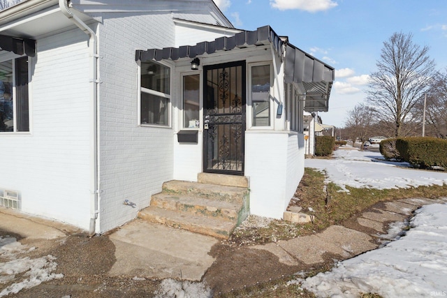 view of snow covered property entrance