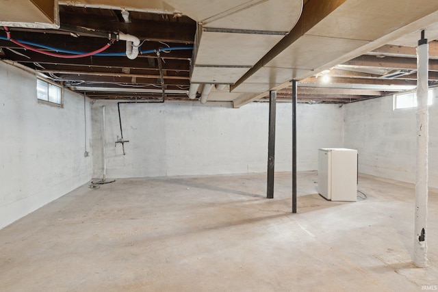 basement featuring white fridge