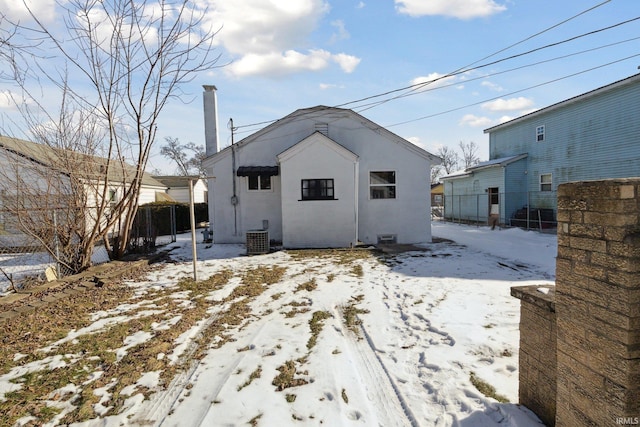 snow covered property featuring central AC