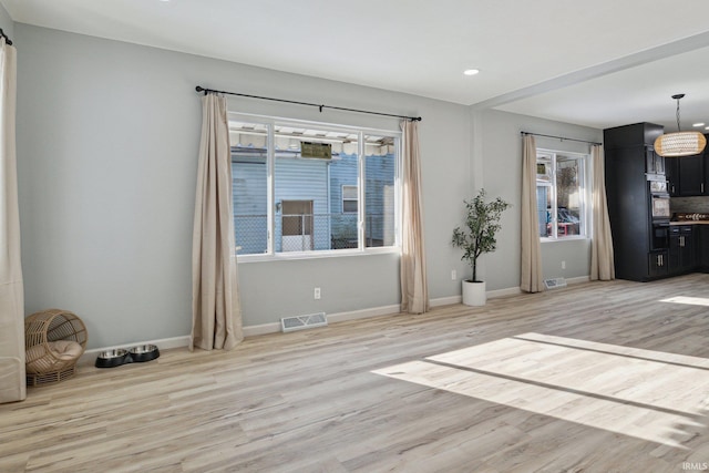 empty room with light hardwood / wood-style floors