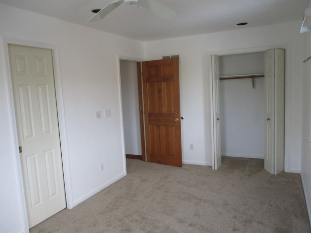 unfurnished bedroom featuring light colored carpet and ceiling fan