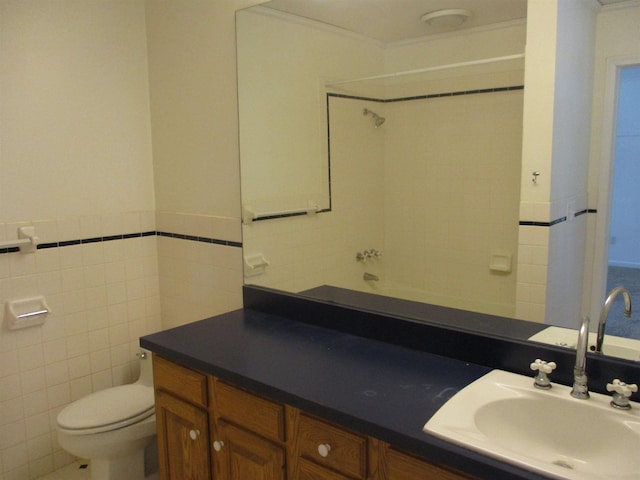 bathroom featuring vanity, tile walls, and toilet