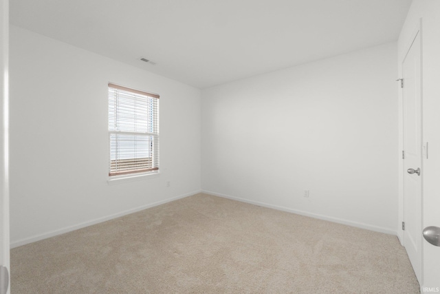 empty room featuring light colored carpet