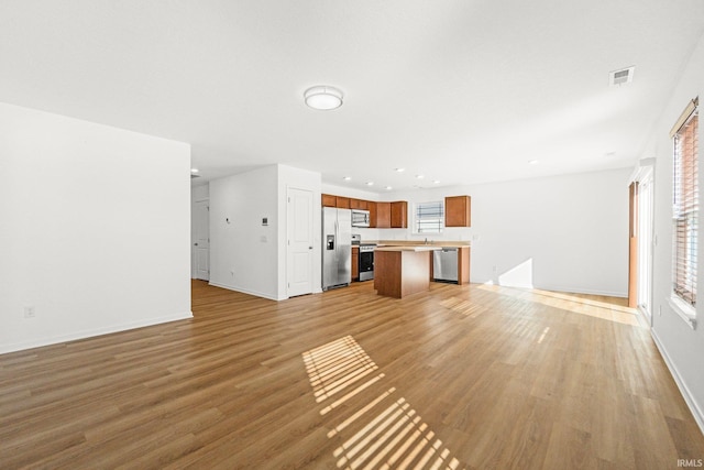 unfurnished living room featuring light hardwood / wood-style floors and a wealth of natural light