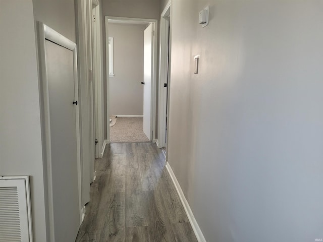 hallway with dark hardwood / wood-style floors