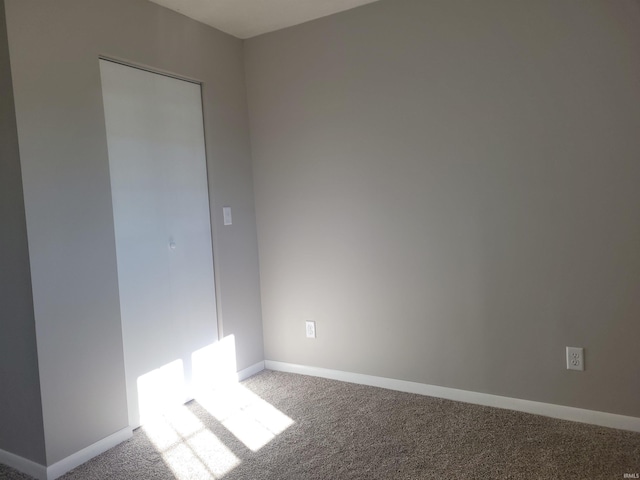 unfurnished room featuring carpet