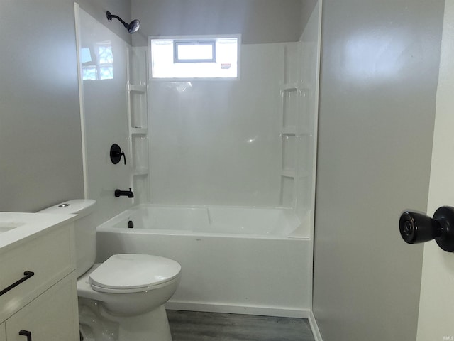 full bathroom with vanity, wood-type flooring,  shower combination, and toilet