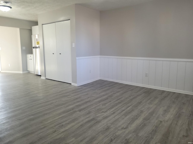 spare room with dark wood-type flooring