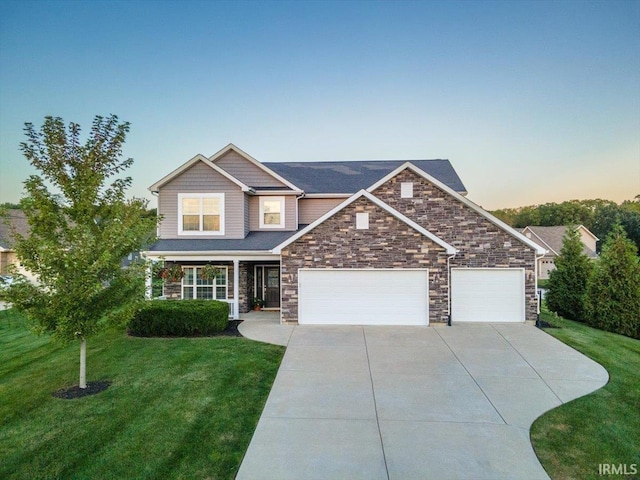 craftsman house featuring a garage and a lawn