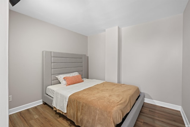 bedroom with dark hardwood / wood-style flooring