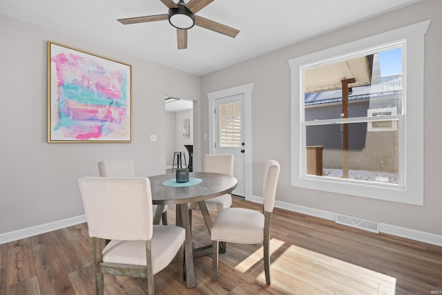 dining space featuring hardwood / wood-style floors and ceiling fan