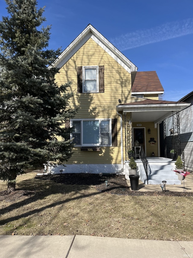 view of front of home with a porch and a front yard