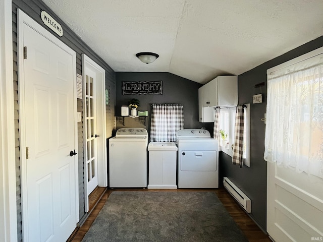 clothes washing area featuring dark hardwood / wood-style floors, a baseboard radiator, separate washer and dryer, cabinets, and a textured ceiling