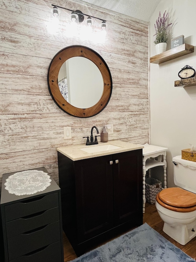 bathroom with vanity, hardwood / wood-style floors, and toilet