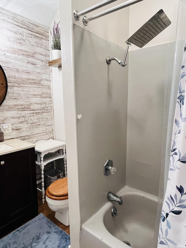 bathroom with a textured ceiling, shower / tub combo with curtain, wooden walls, and toilet