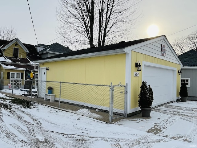 view of snowy exterior with a garage