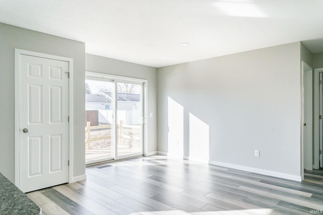 spare room with light hardwood / wood-style flooring