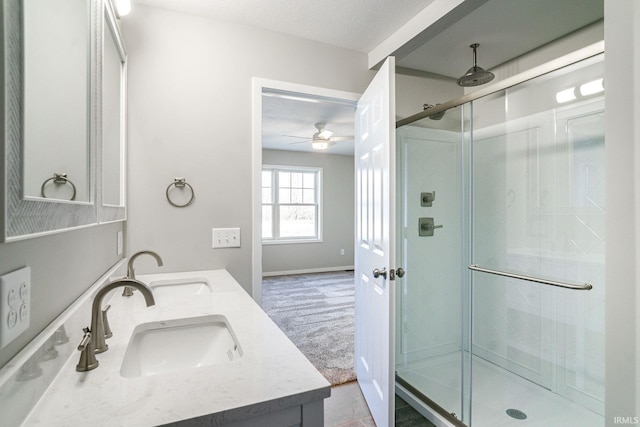 bathroom featuring walk in shower, vanity, and a textured ceiling